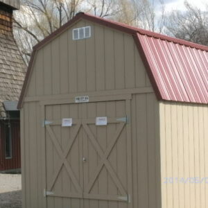 Loft Style wood shed with double doors and a red metal roof
